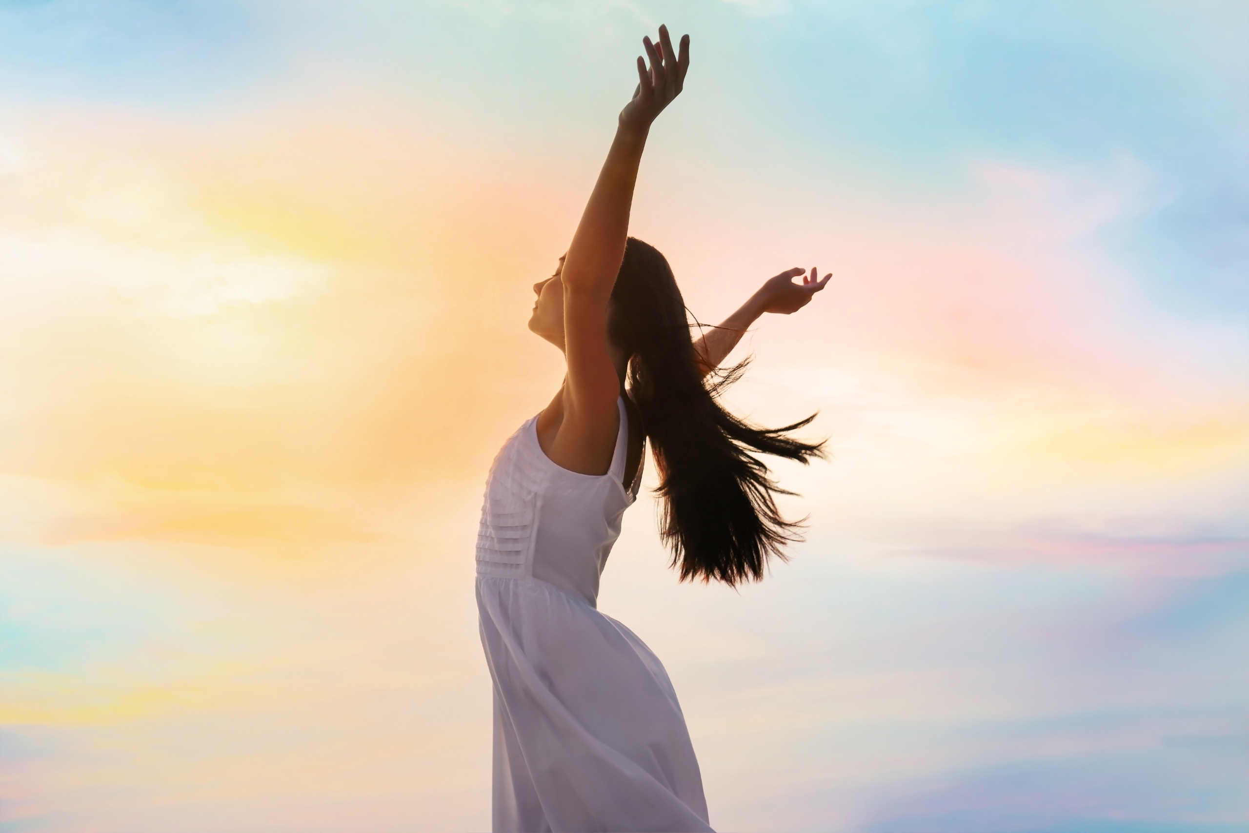 Young woman enjoying summer day against sky. Freedom of zen.